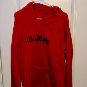 Red “be happy hoodie” with black smile on back.